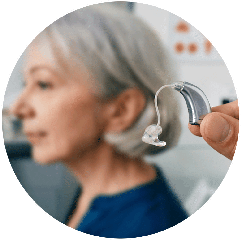 Woman at her audiologist retrieving her newly repaired hearing aids